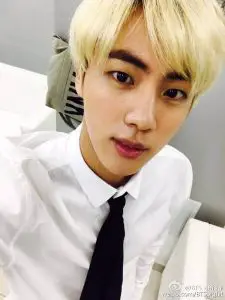 A blonde side part of Jin