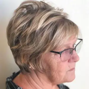 Blonde pixie hairstyle with dark roots