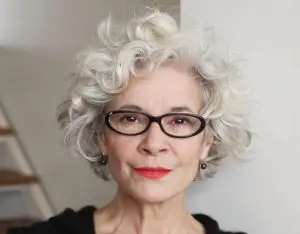 Hairstyle with curly hair for woman over 50 with glasses